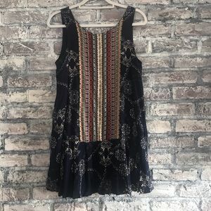Boho style mini dress, fully lined, keyhole opening in back with ties & tassels.